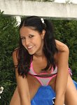 Hot brunette teen in fishnet micro bikini gets naughty and flashes her shaved pussy poolside